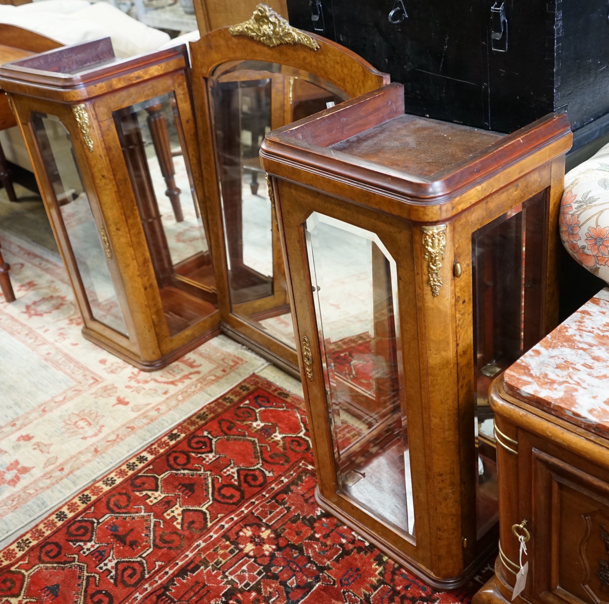 A pair of early 20th French birds eye maple glazed cabinets and central mirror, formerly a cabinet superstructure, total width approximately 156cm